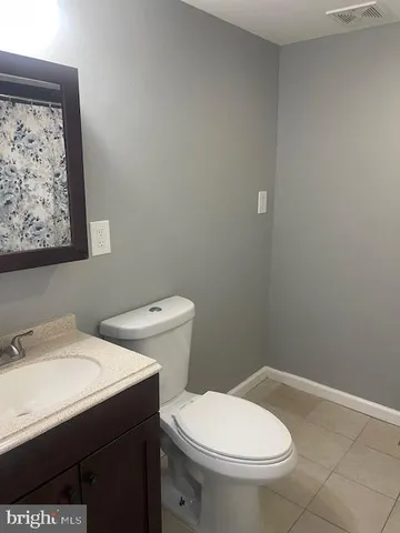 a white toilet sitting next to a bathroom sink