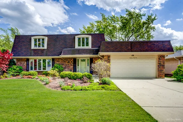 a front view of house with yard and green space