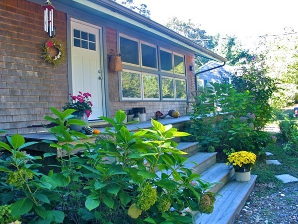 100 Franklin Avenue Tisbury, MA 02568 - Photo 1 of 18 a backyard of a house with lots of green space