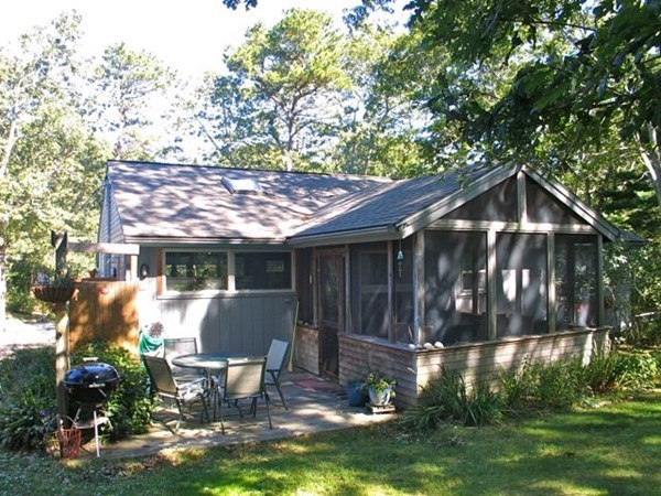 100 Franklin Avenue Tisbury, MA 02568 - Photo 15 of 18 a view of a chair and table in backyard of the house