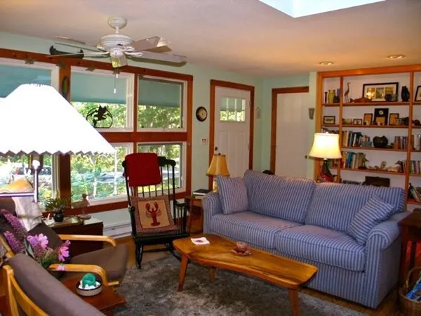 a living room with furniture a rug and a window