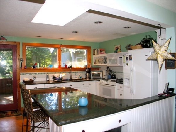 100 Franklin Avenue Tisbury, MA 02568 - Photo 7 of 18 a kitchen with stainless steel appliances granite countertop a sink and a stove