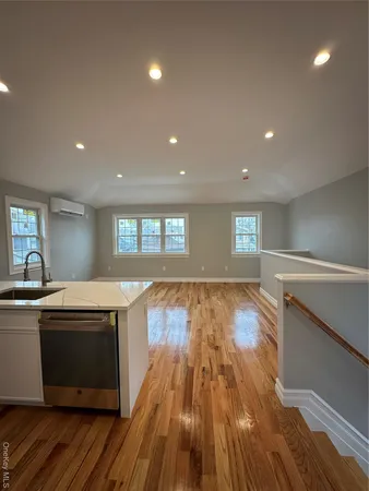 a view of kitchen with a sink and wooden floor