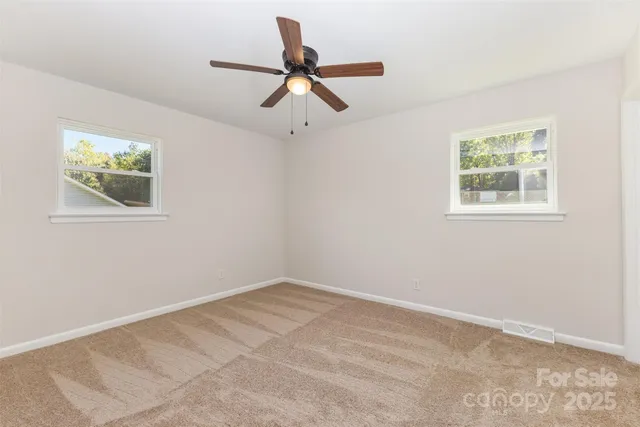 a view of room with a ceiling fan and window