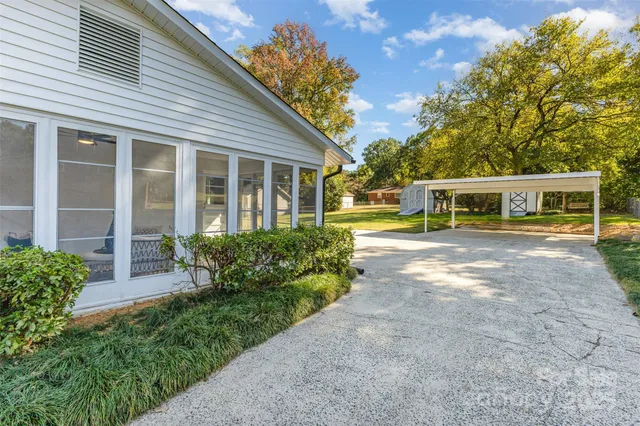 a front view of a house with a yard and potted plants
