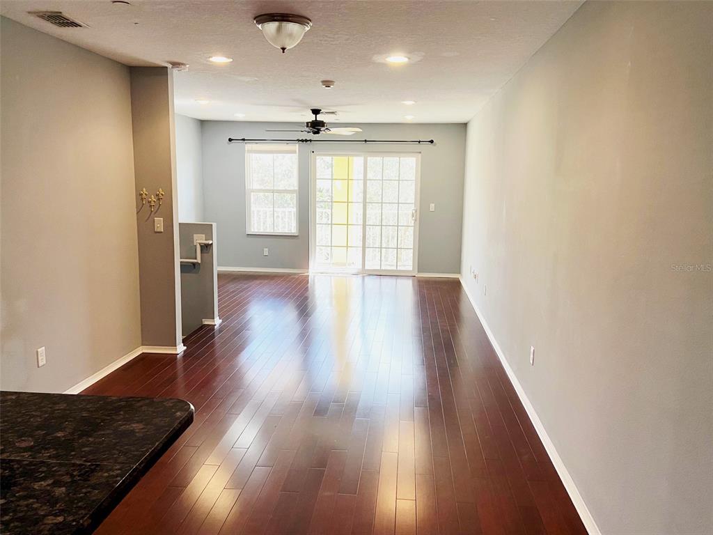 8946 White Sage Loop Lakewood Ranch, FL 34202 - Photo 5 of 36 a view of an empty room with wooden floor and a window