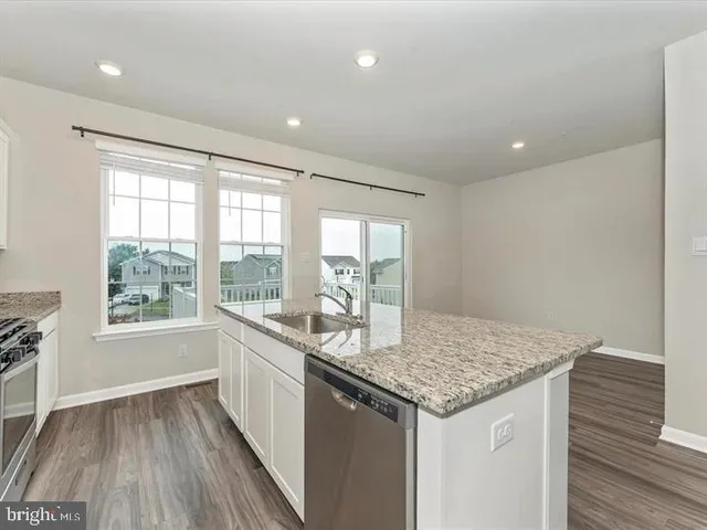 a kitchen with sink and wooden floor