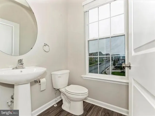a bathroom with a toilet a sink and a mirror