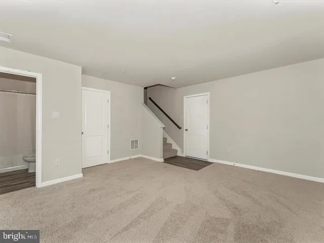 a view of an empty room with stairs
