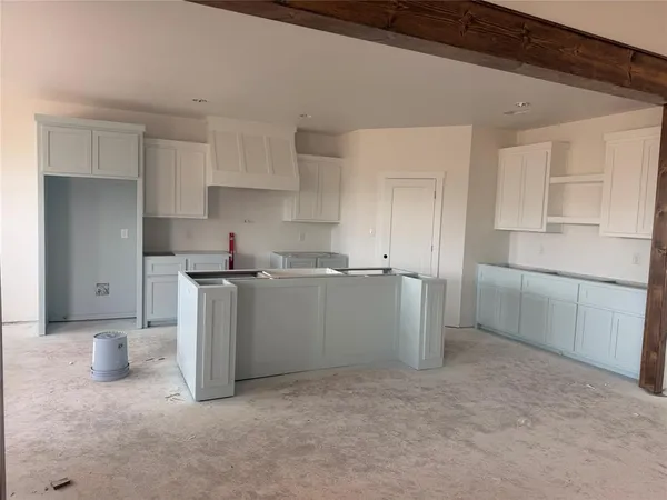 a kitchen with cabinets and window