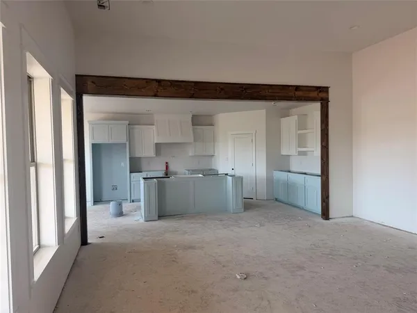 a view of a kitchen with a sink and a refrigerator