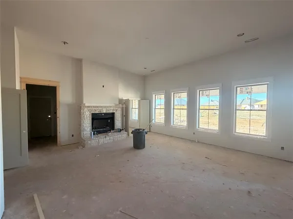a view of an empty room with a fireplace