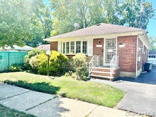 220-26 138th Road Queens, NY 11413 - Photo 1 of 1 a front view of a house with a yard