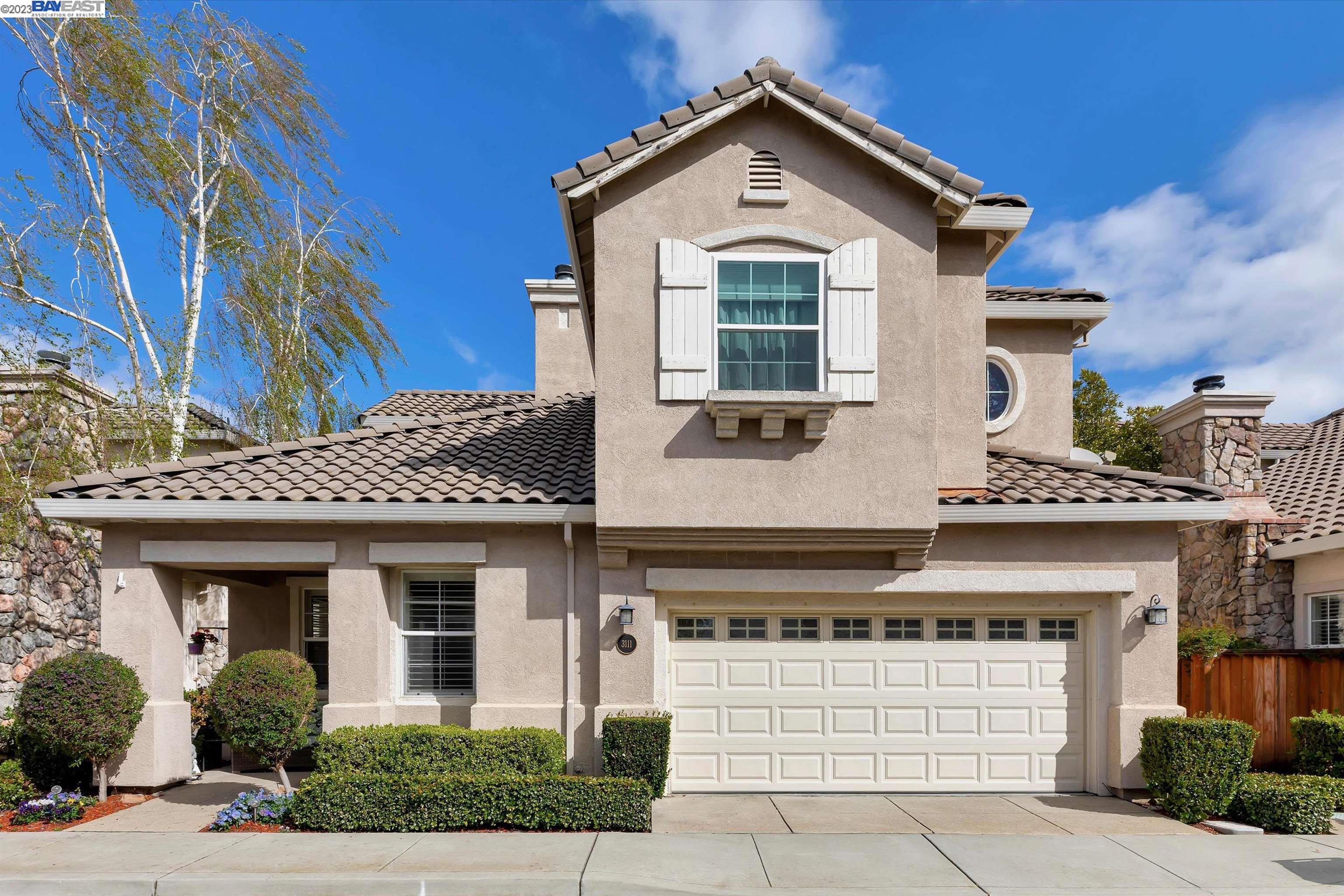 a front view of a house with a garage