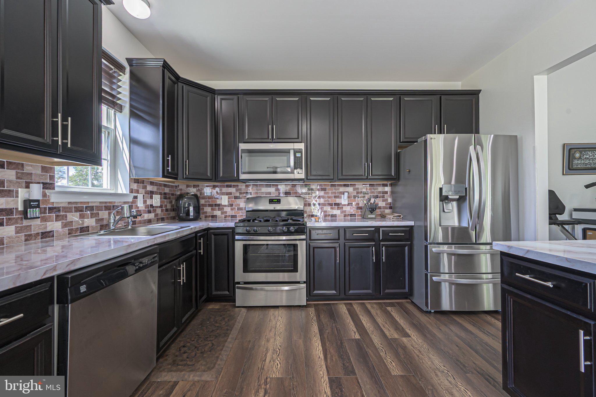 1092 Chews Landing Road Clementon, NJ 08021 - Photo 20 of 41 Sleek modern kitchen with rich tones.