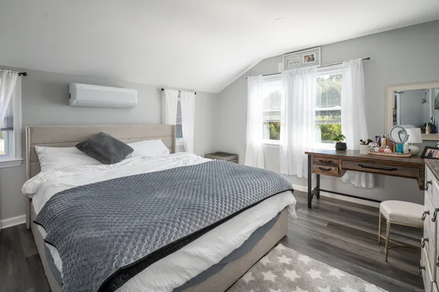 a bedroom with a bed and window