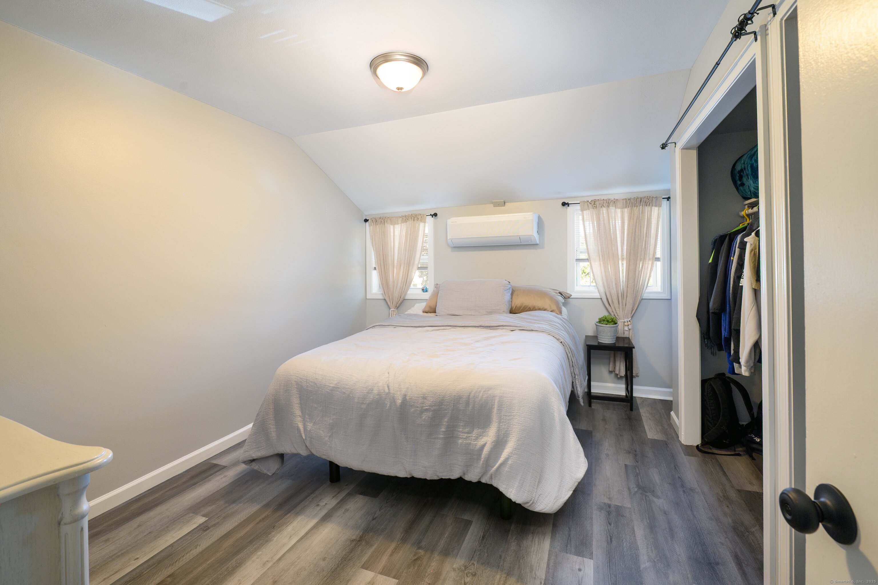 Beach Road Old Saybrook, CT 06475 - Photo 5 of 16 a bedroom with a bed and wooden floor