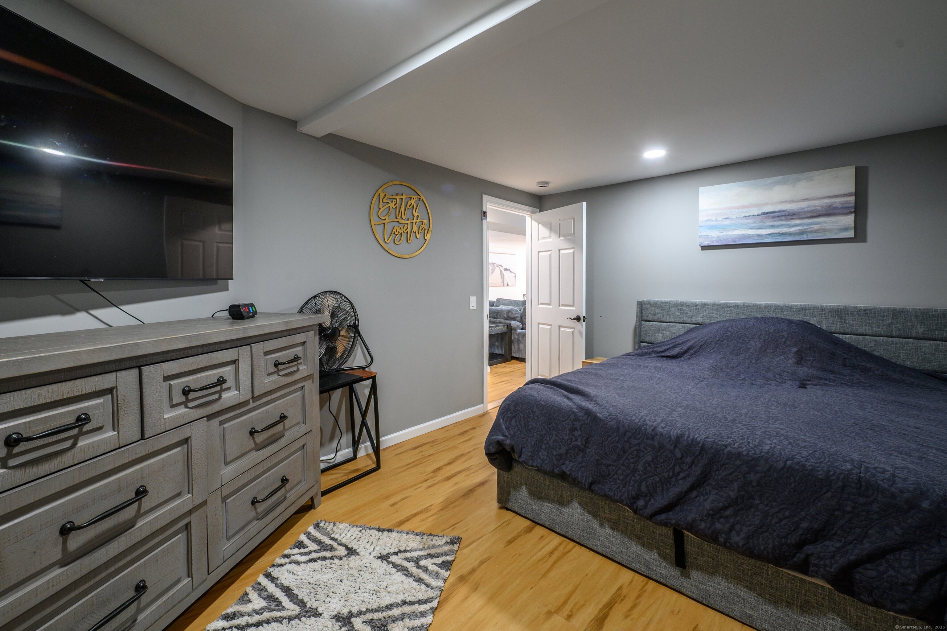 Beach Road Old Saybrook, CT 06475 - Photo 10 of 16 a bedroom with a bed and a flat screen tv