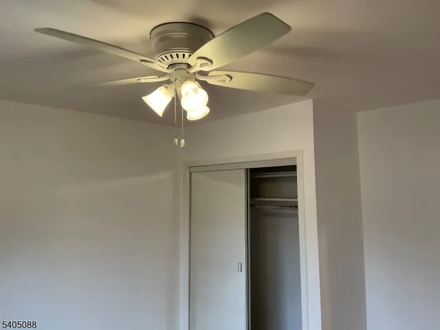 a view of a chandelier fan in a room