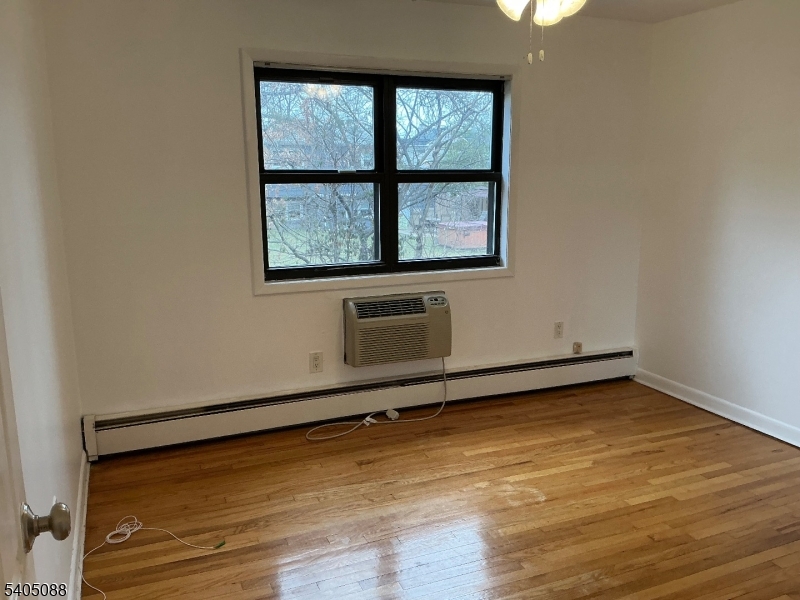 6 Colonial Drive, Unit A Little Falls, NJ 07424 - Photo 4 of 7 a view of a room with wooden floor and window