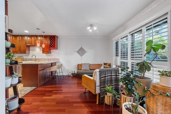 a kitchen with a sink a counter space dining table and chairs