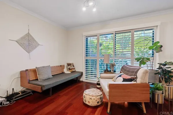 a bedroom with a bed and a potted plant