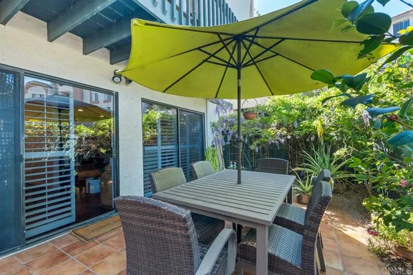 a bedroom with a bed gym equipment and large windows