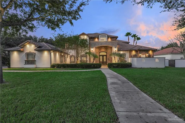 a front view of house with yard and green space