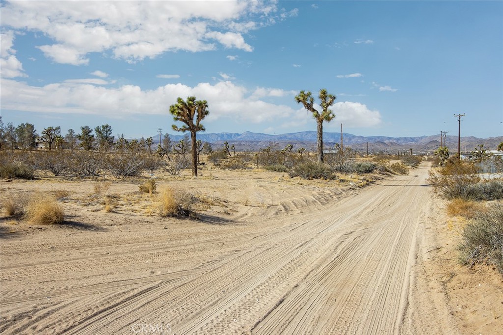 4 Burke Road Yucca Valley, CA 92284 - Photo 4 of 20 a view of a road with a snow on the road