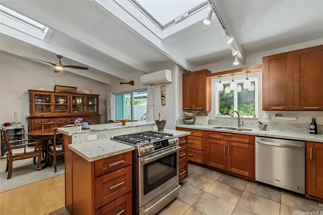 a kitchen with a stove sink and cabinets