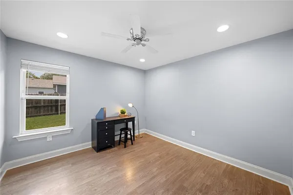 an empty room with a window and fireplace