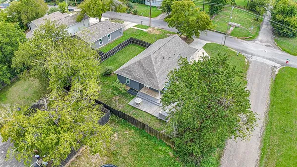 an aerial view of a house with a yard