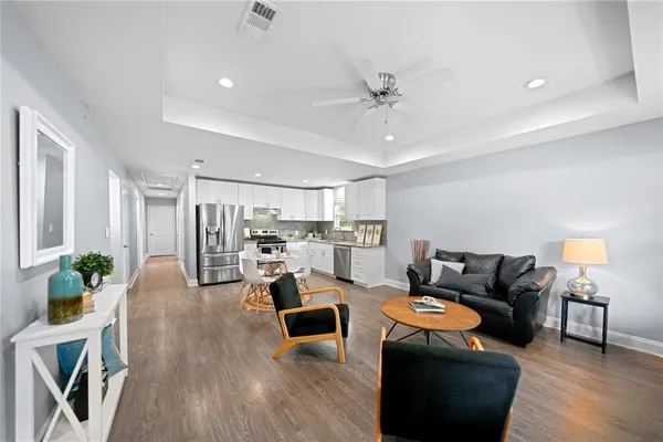 a living room with furniture and wooden floor