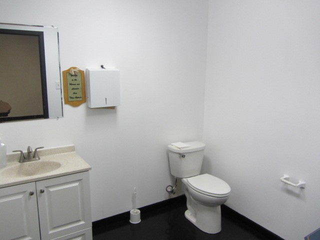 228 Farm To Market Road 3478 Huntsville, TX 77320 - Photo 18 of 28 a bathroom with a toilet a sink and mirror