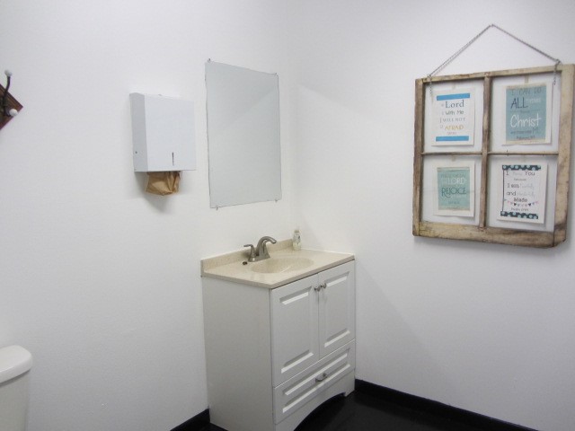 228 Farm To Market Road 3478 Huntsville, TX 77320 - Photo 19 of 28 a bathroom with a toilet a sink and mirror