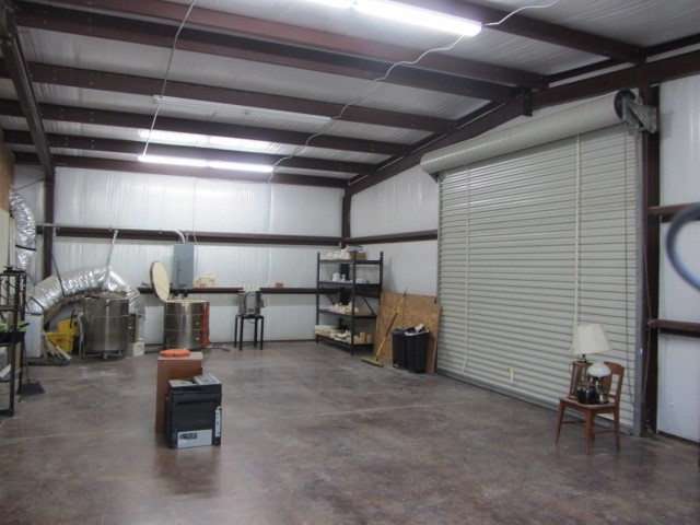 228 Farm To Market Road 3478 Huntsville, TX 77320 - Photo 26 of 28 a view of a garage with storage