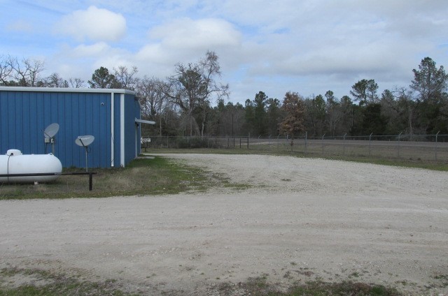 228 Farm To Market Road 3478 Huntsville, TX 77320 - Photo 5 of 28 a view of a dry yard