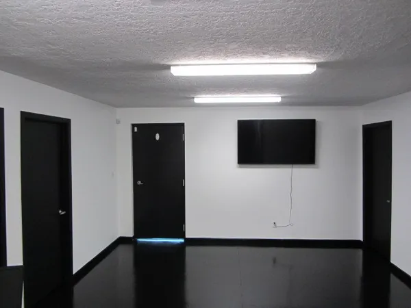 a kitchen with a table chairs refrigerator and cabinets