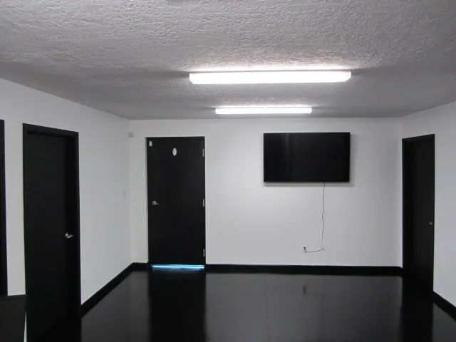 a kitchen with a table chairs refrigerator and cabinets