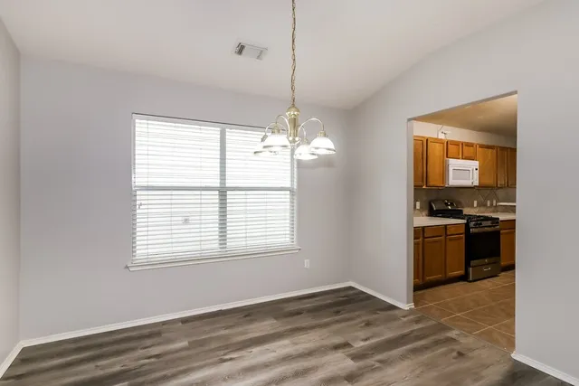 a view of a kitchen with a stove cabinets and a wooden floor