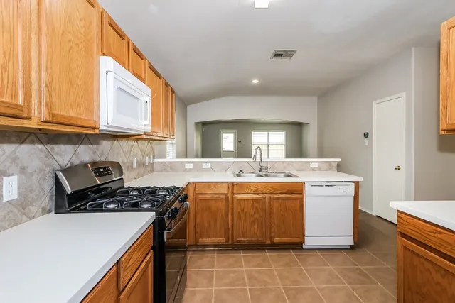 a kitchen with a stove and a sink