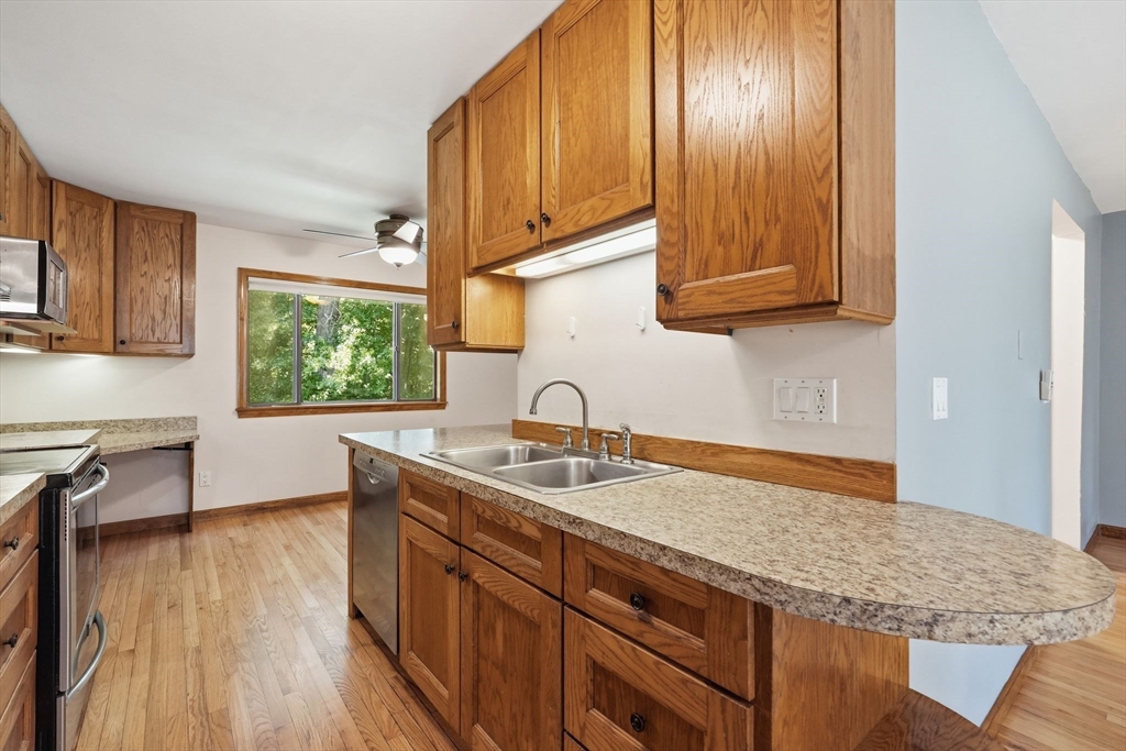 170 East Hadley Road, Unit 96 Amherst, MA 01002 - Photo 7 of 36 a kitchen with a sink cabinets and wooden floor
