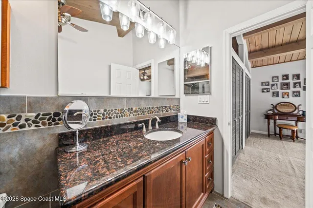 a bath room with a sink and a mirror