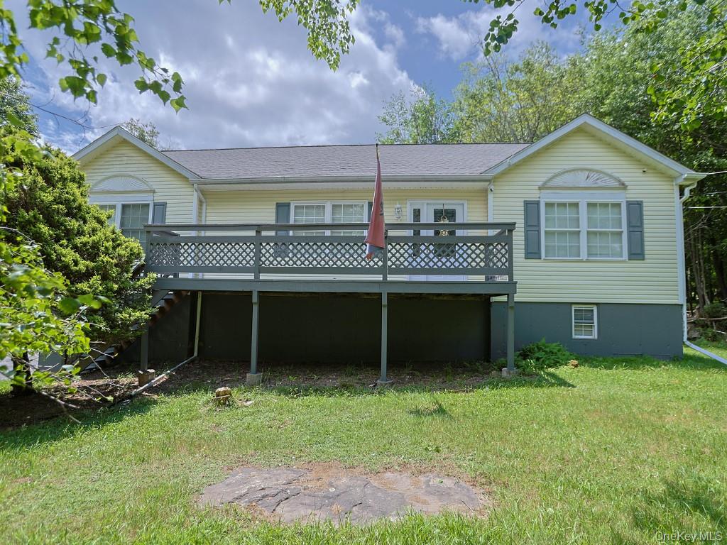 20 Haddock Road Monticello, NY 12701 - Photo 1 of 1 Back of house featuring a wooden deck and a yard