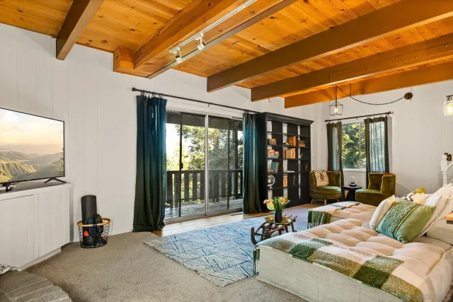 a bedroom with furniture and large windows