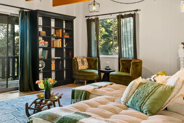 a living room with furniture flowerpot and wooden floor