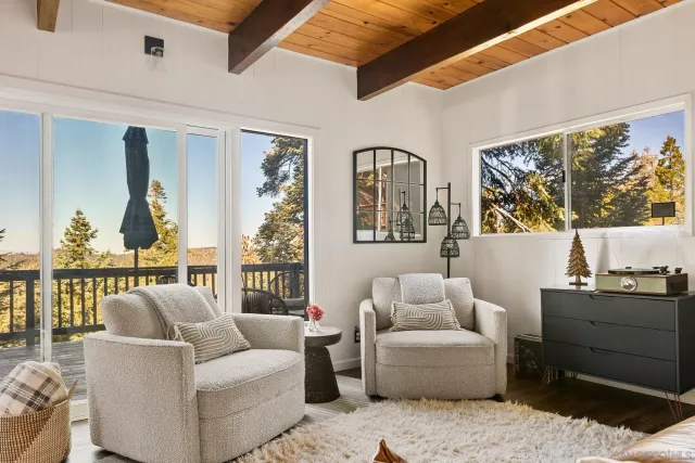a living room with furniture a window and a flat screen tv
