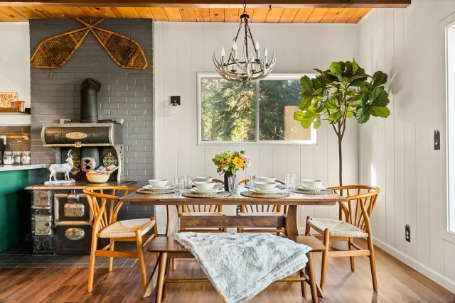a view of a dining room with furniture wooden floor and chandelier