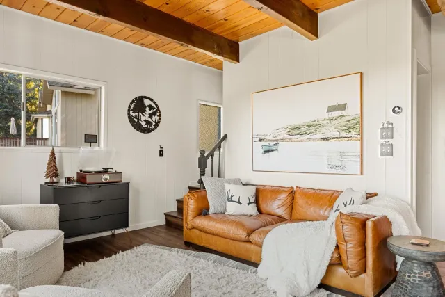 a living room with furniture and wall paintings