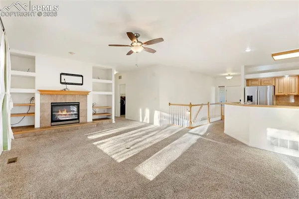 a view of livingroom with furniture fireplace and a window